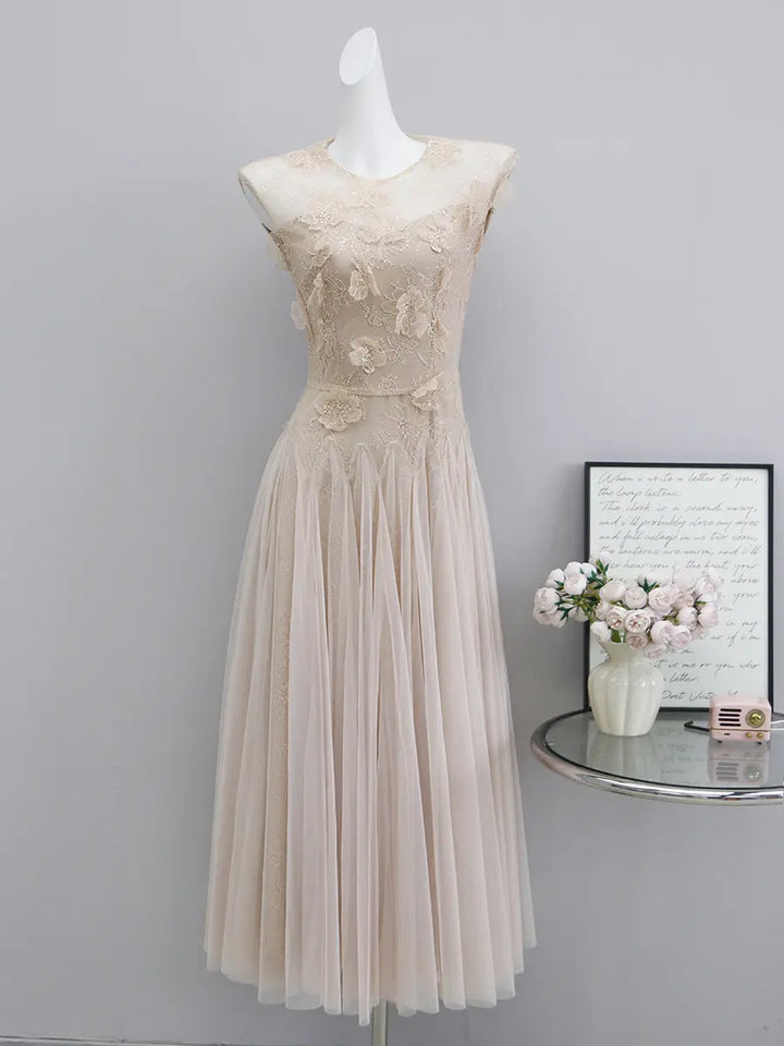 Elegant blush pink tulle A-line evening gown with intricate floral lace bodice and cap sleeves, floor-length design.
