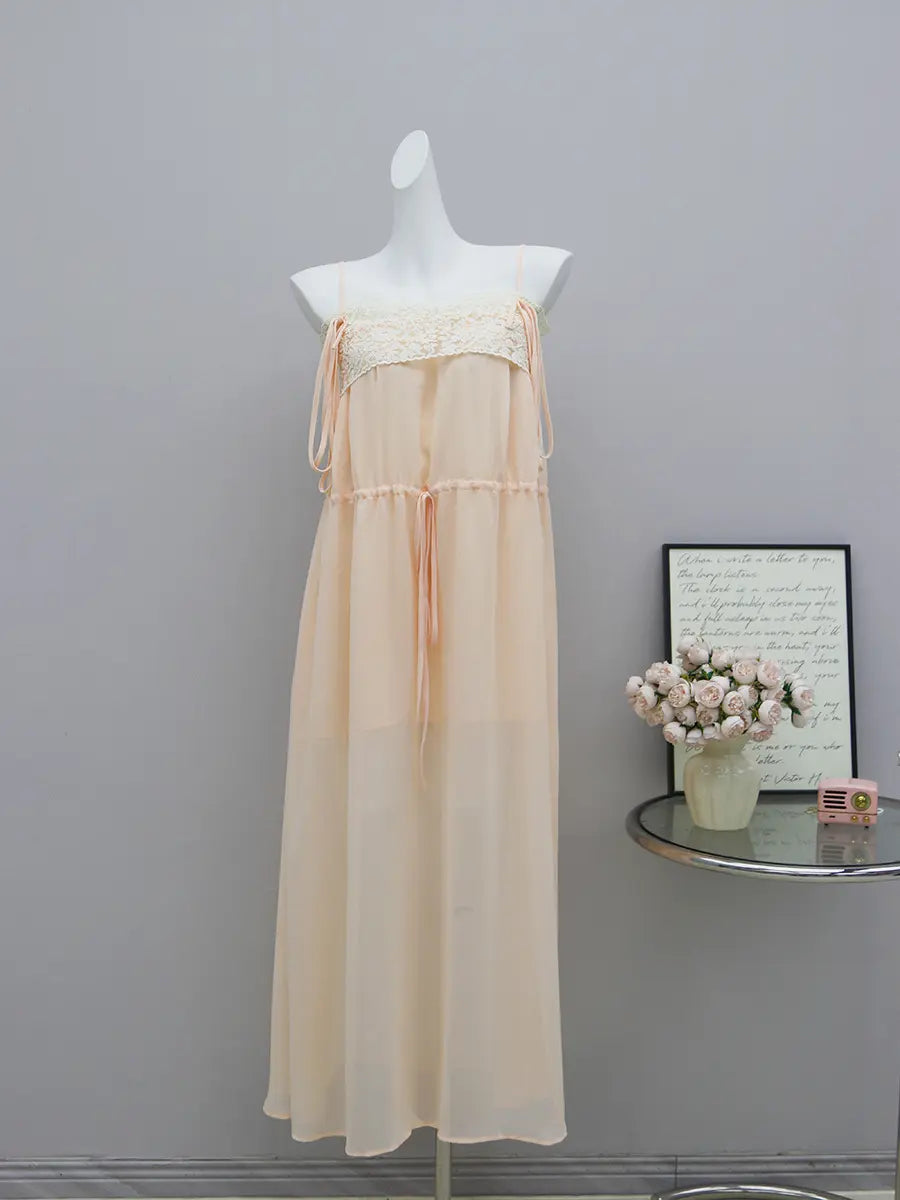 Pale peach-nude sheer chiffon maxi dress with intricate floral lace bodice and adjustable spaghetti straps, shown on a mannequin with a drawstring waist.