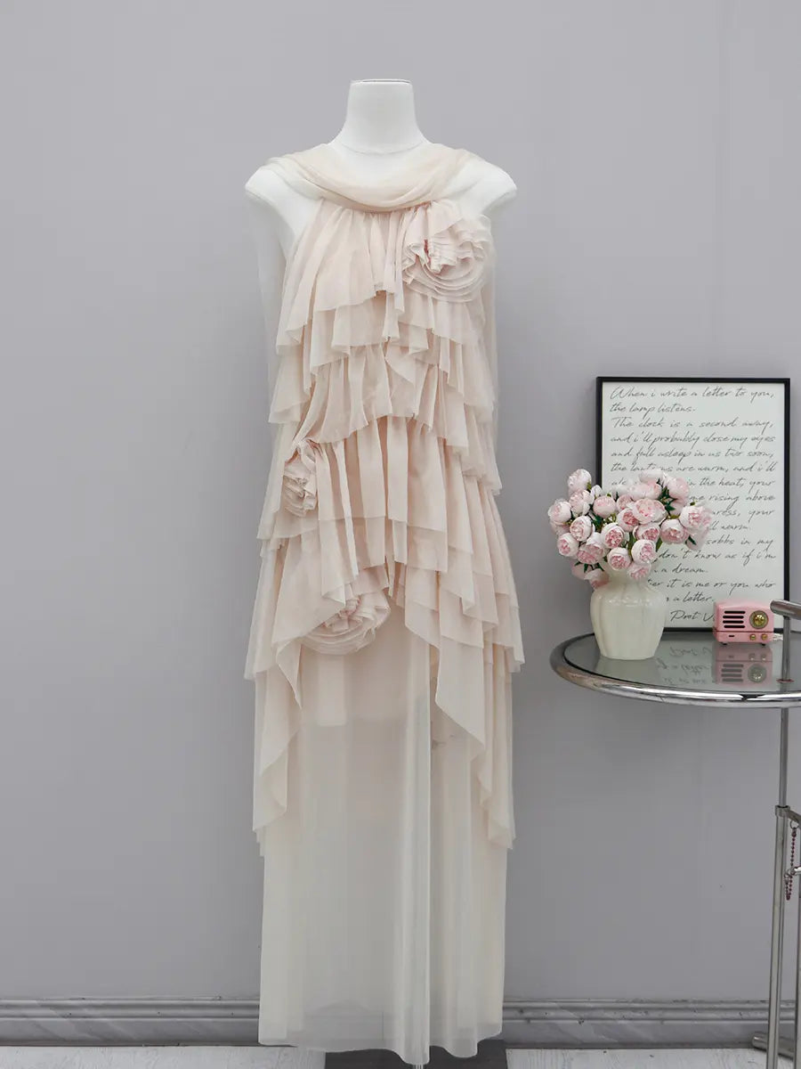 Zynka ethereal maxi dress featuring cascading layered ruffles and delicate fabric roses in a pale nude hue, shown from the front on a mannequin.